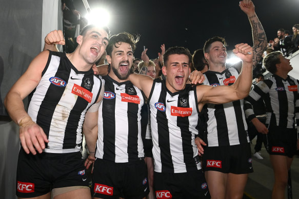 The Pies celebrate their semi-final win on Saturday night.