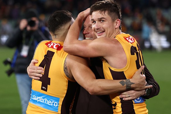 Jarman Impey and coach Sam Mitchell celebrate with Butler after the semi-final win.