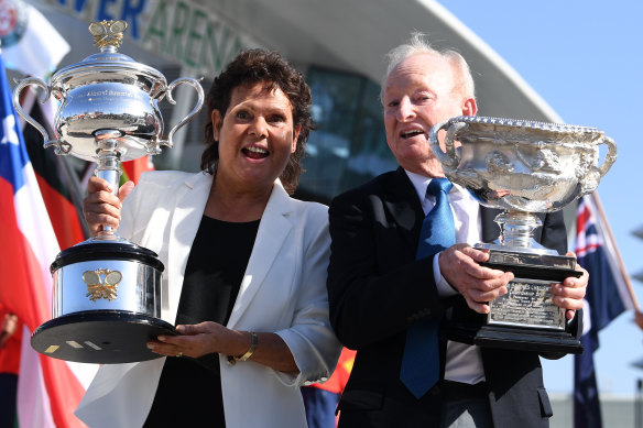 Evonne Goolagong Cawley and Rod Laver hold the men's and women's trophies on day one of the Australian Open last year.
