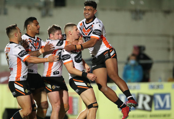 Adam Doueihi (second from right) celebrates with teammates after scoring a try on Saturday night.