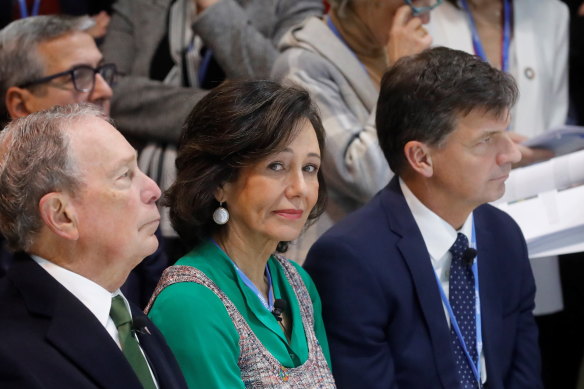 Angus Taylor, right, attends the UN climate summit in Madrid. He is pictured with Michael Bloomberg, left, and Spanish Banco Santander bank's chairwoman, Patricia Botin.