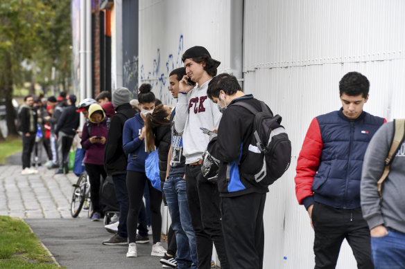 
International students and others who didn’t qualify for government support queue in Melbourne’s Southbank for food charity in April, 2020.