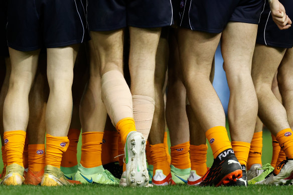 Blues players wear orange socks as part of the Carlton Respects campaign during the 2021 season.