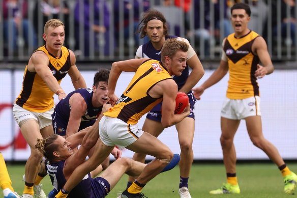 Hawthorn’s Harry Morrison looks to break free from a Nat Fyfe tackle.