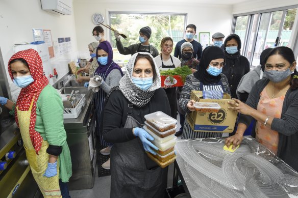 Afshan Mantoo (centre) and her group of volunteers preparing food at their kitchen in Coburg.