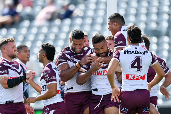The Sea Eagles celebrate after scoring first against the Roosters.