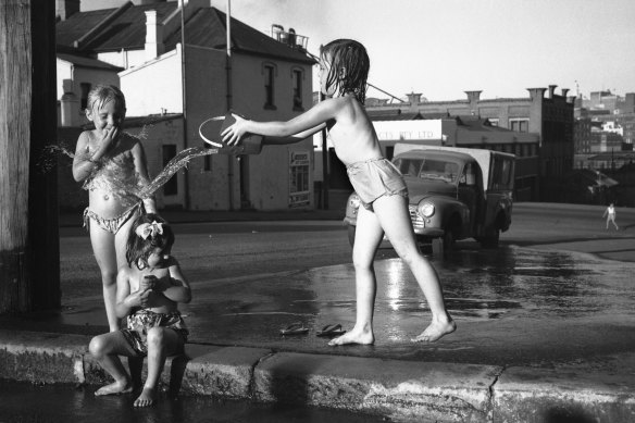 "Children try to cool down during January heatwave conditions." January 26, 1960