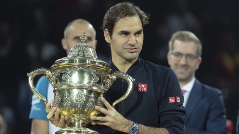 Roger Federer claims the spoils of victory at the Swiss Indoors in Basel.