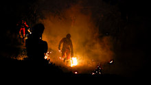 Members of the Emergency Military Unit (UME) utilize controlled burns to halt the spread of wildfires in the Madrid border region.