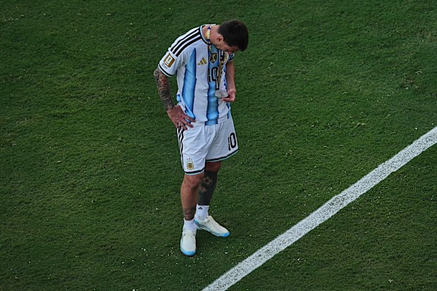 Lionel Messi inspects his medal after Argentina’s World Cup final loss.