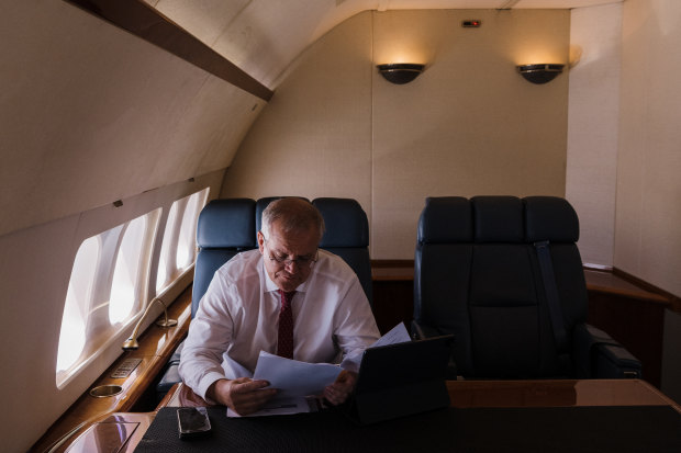 Work to be done: Morrison on board a RAAF Boeing 737 from Sydney to Brisbane.