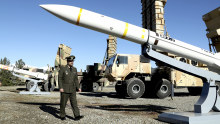 General Mohammad Reza Gharaei Ashtiani reviews the domestically built Arman air defence system, during its unveiling ceremony with a Sayyad-3 missile, in the foreground.