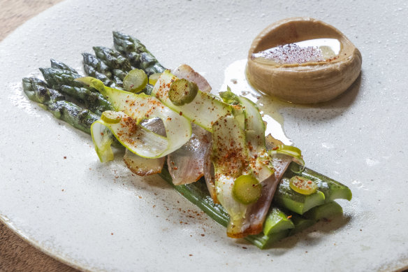 Asparagus prepared three ways is plated with guanciale (cured pork cheek) and comte custard.