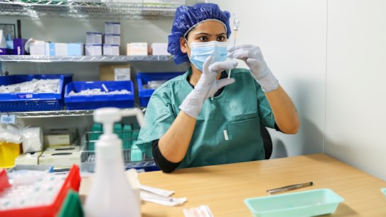 The Pfizer vaccine is prepared by a nurse at the Canberra Hospital as more under 40s became eligible for vaccination in August.