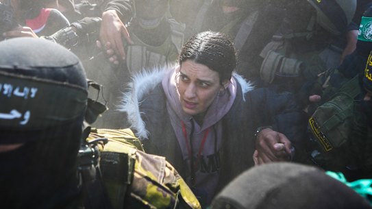 Arbel Yehoud who had been held hostage since October 7, 2023, is escorted by Hamas and Islamic Jihad fighters to be handed over to the Red Cross in Khan Younis, Gaza.