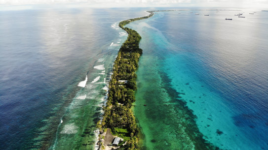 A strip of land between the Pacific Ocean, left, and lagoon in Funafuti, Tuvalu. The low-lying South Pacific island nation of about 12,000 people has been classified as ‘extremely vulnerable’ to climate change by the UN.