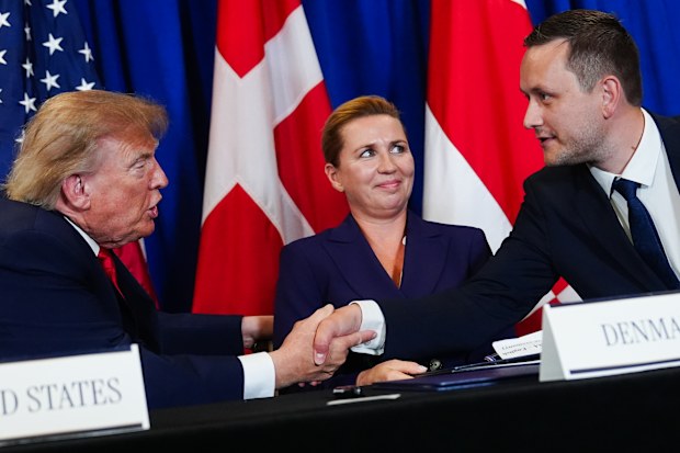 President Donald Trump, left, shakes hands with Greenland’s Prime Minister Jens-Frederik Nielsen, right, as Denmark’s Prime Minister Mette Frederiksen, centre, watches.