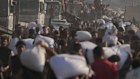 Palestinians carry sacks of flour unloaded from a humanitarian aid convoy that reached Gaza City on Saturday.
