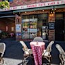 Outside the shop, where sunny streetside seating is available.