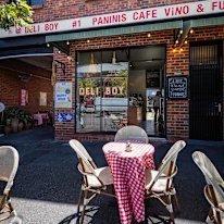 Outside the shop, where sunny streetside seating is available.