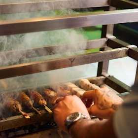 Yakitori is cooked on a robata grill.