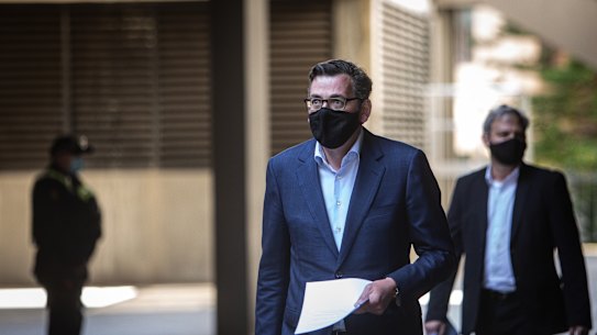 Premier Daniel Andrews and Chief Health Officer Brett Sutton arrive for a media briefing last month.