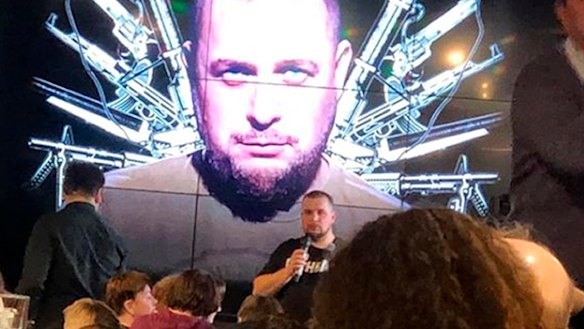 Russian blogger Vladlen Tatarsky speaks in front of projection of an image of himself before the explosion.
