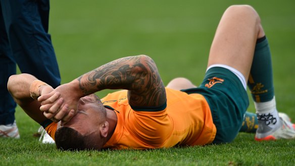 A distraught Quade Cooper lies on the turf in Mendoza.