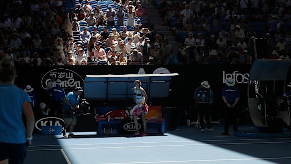 Petra Kvitova waits as officials close the roof on Rod Laver Arena.