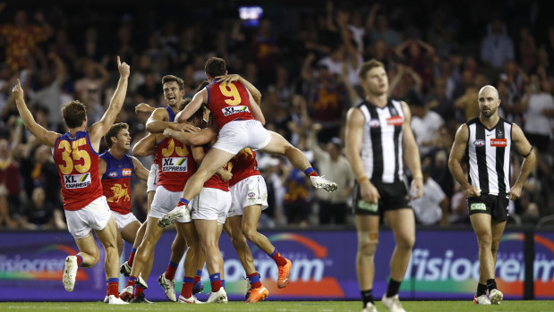 Brisbane players celebrate an after-the-siren goal by Zac Bailey. 