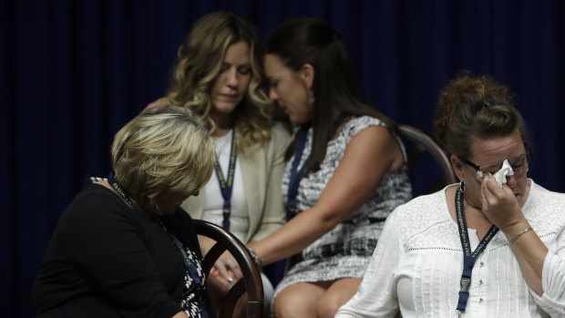 Victims of clergy sexual abuse, or their family members react as Pennsylvania Attorney General Josh Shapiro speaks during a news conference at the Pennsylvania Capitol in Harrisburg.