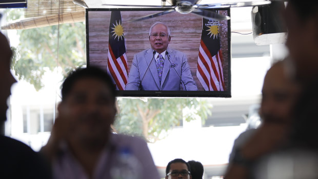 Malaysian PM Najib Razak is seen on television announcing he obtained consent from Malaysia's king to dissolve Parliament.