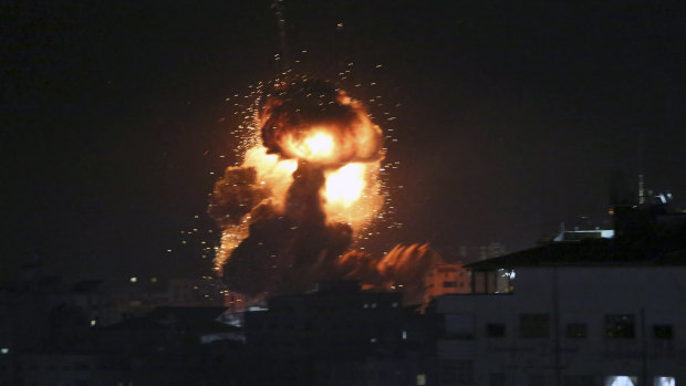 An explosion caused by Israeli airstrikes is seen from the offices of a Hamas leader in March.