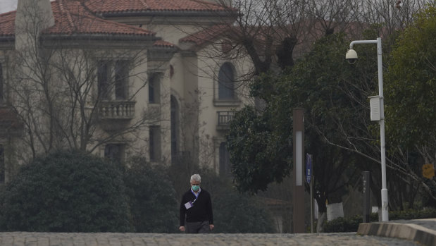 Dominic Dwyer of a World Health Organisation team walks in the cordoned hotel area in Wuhan.