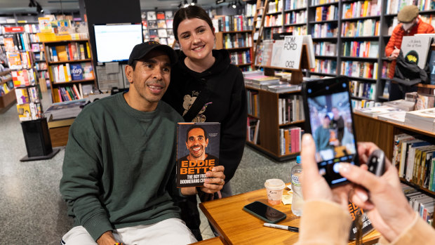 Eddie Betts signs copies of his book at Readings last week.