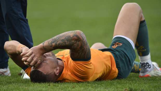 A distraught Quade Cooper lies on the turf in Mendoza.