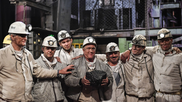 Miners hold the last lump of coal during a closing ceremony of the last German coal mine Prosper-Haniel in Bottrop on December 21, 2018. 