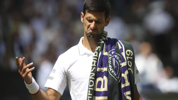 Djokovic reacts to the crowd's cheers for his rival Roberto Bautista Agut's.