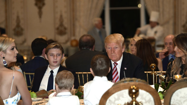 Trump, centre, and first lady Melania Trump, right, sit with their family for Thanksgiving dinner.