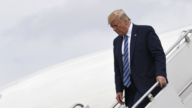 President Donald Trump walks down the steps of Air Force One on Tuesday as he returns to his golf club after visiting Pennsylvania. 
