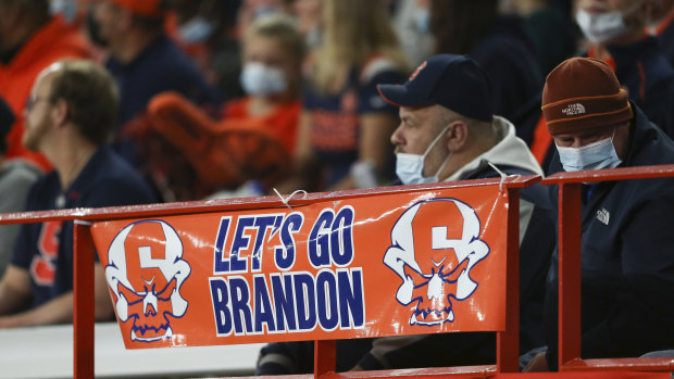 A sign reading “Let’s go Brandon” is displayed on the railing in the first half of an NCAA college football game in Syracuse, NY, on Saturday.