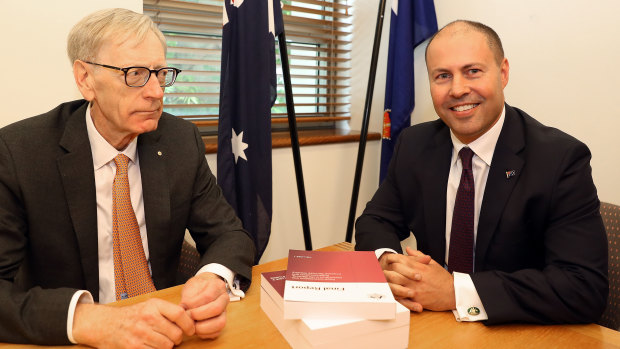 Pretty uncomfortable: Commissioner Kenneth Hayne and Josh Frydenberg at their extremely awkward photo opportunity on Friday.