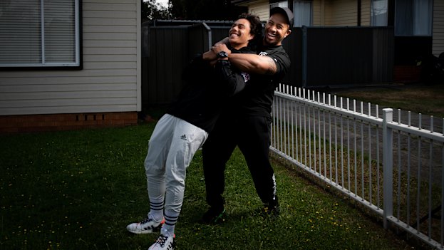 Martin wrestles with his son Jarome outside their Dharruk home during the week.