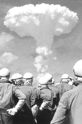 People observe atomic bomb explosion in an undated photo.