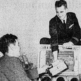 Dr. T. Hurley hands the myanesin to Flt. Lt. Keith Martin, pilot of the mercy plane.