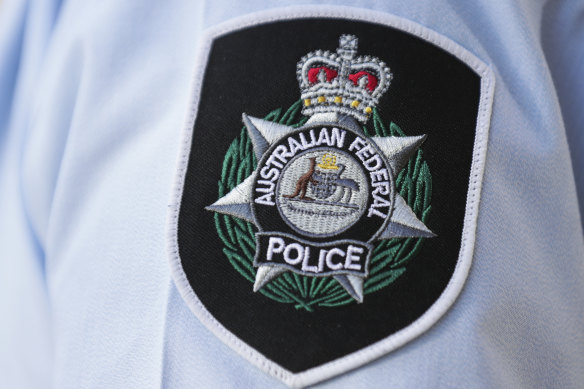 The AFP arrested a man at Brisbane International Airport for allegedly threatening a federal MP. 