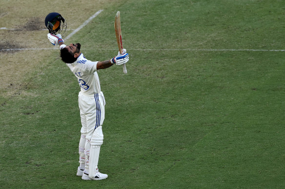 Virat Kohli celebrates reaching a century during day three of the first Test in Perth.