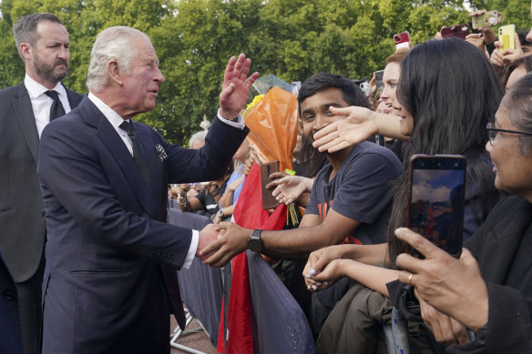 King Charles III greets crowds outside Buckingham Palace.