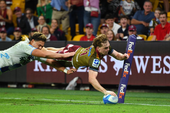 Tim Ryan of the Reds scores one of his three tries.