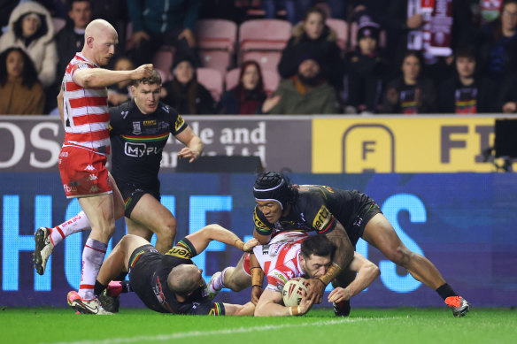 Jake Wardle dives for the tryline as Brian To’o tries to hold the Wigan player up in this year’s World Club Challenge.